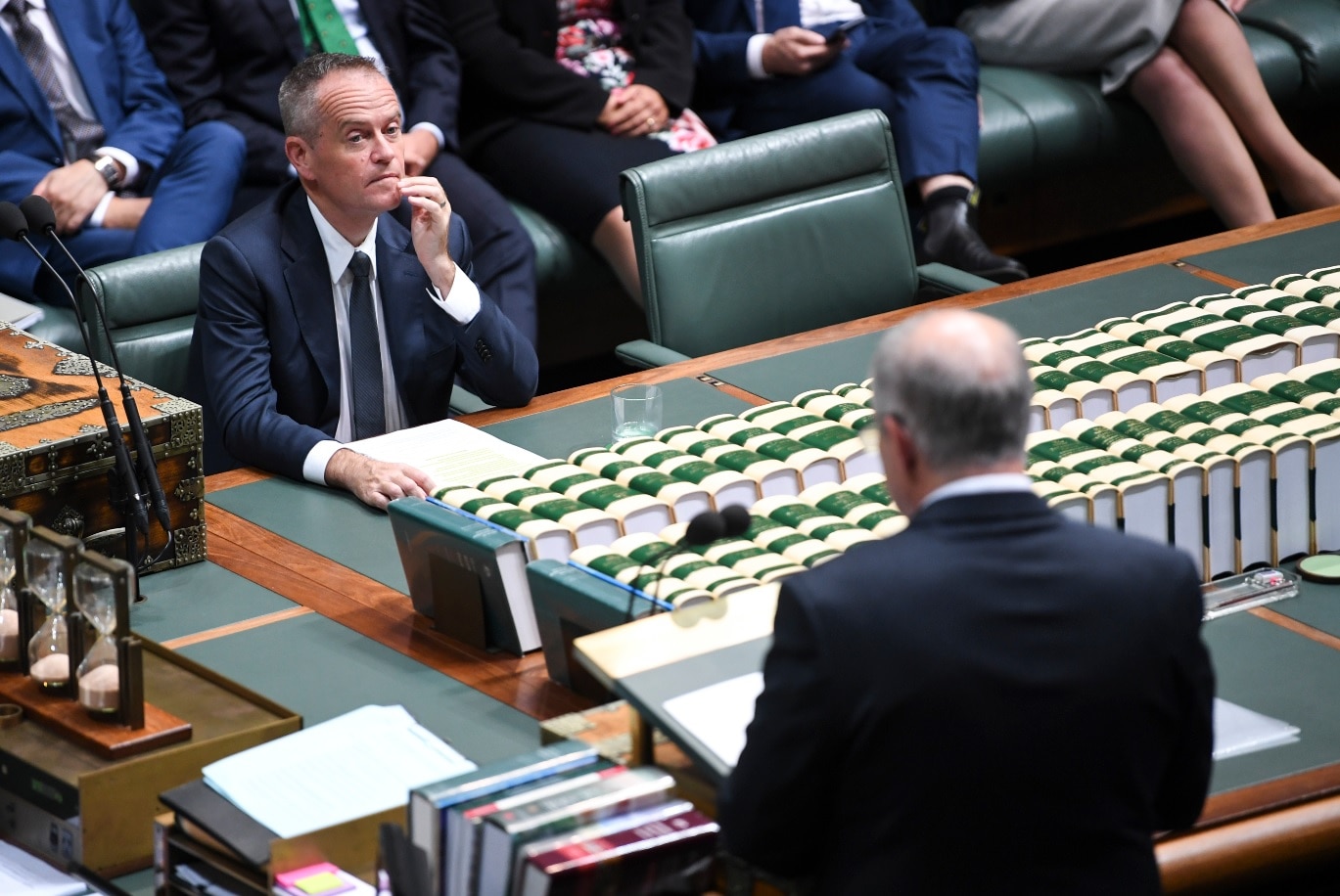 Australian Opposition Leader Bill Shorten reacts as he listens to Australian Federal Treasurer Scott Morrison.