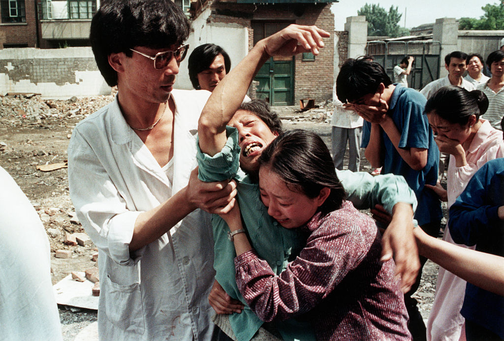 A grief-stricken mother who has just learned of the death of her son, a student protester killed by soldiers at Tiananmen Square. 