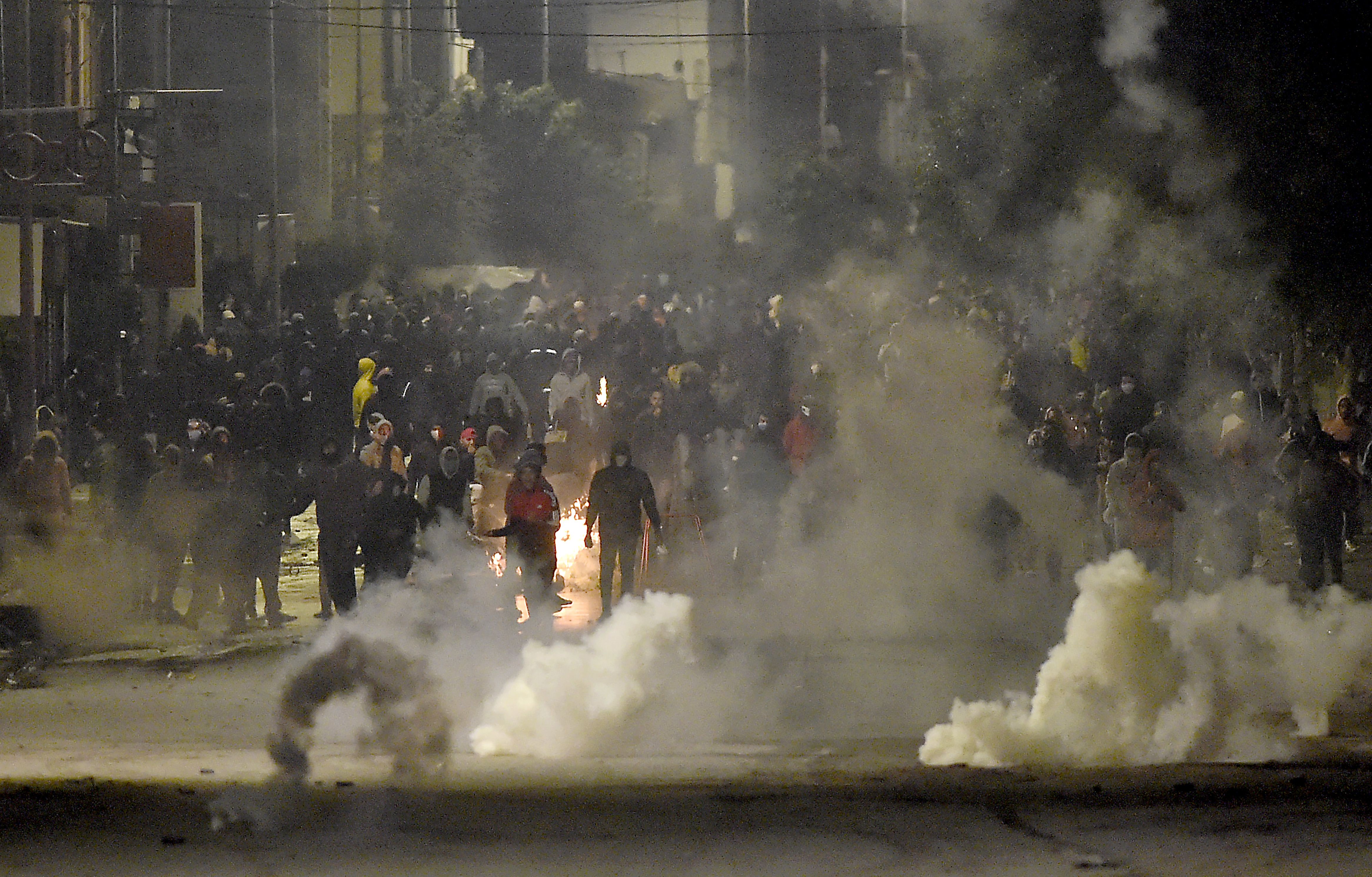 Protesters block a street during clashes with security forces in Ettadhamen on the outskirts of Tunisia's capital Tunis on 18 January.