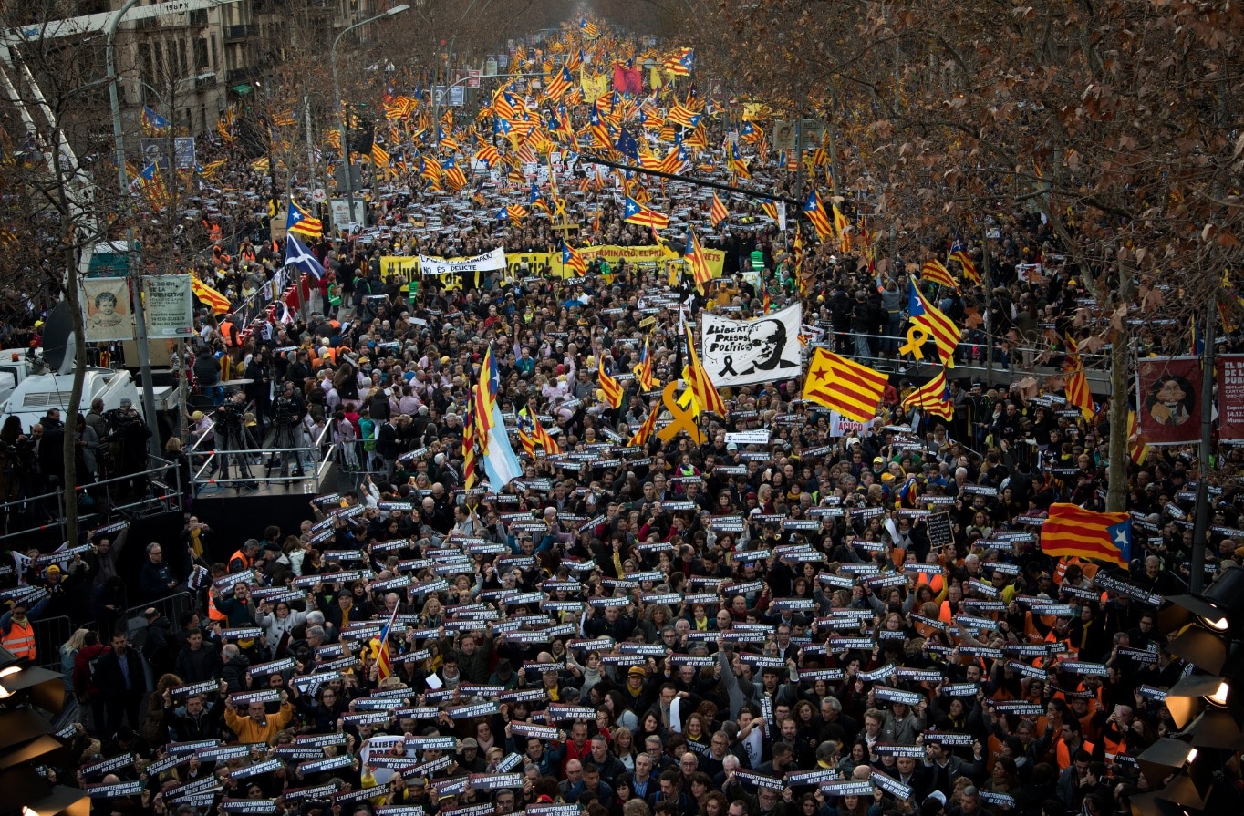 Pro independence demonstrators hold banners that says in Catalan Pro independence demonstrators hold banners that says in Catalan "self-determination is not a crime".