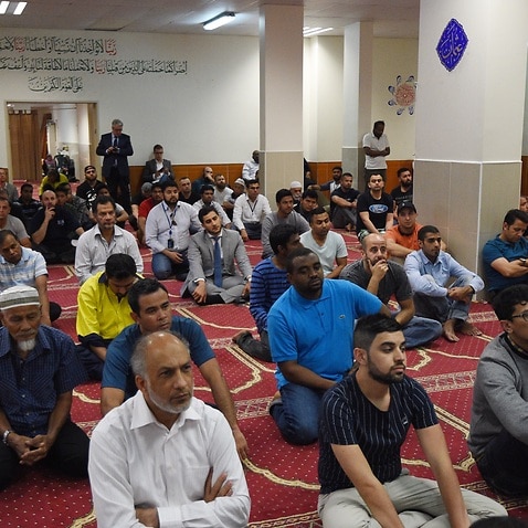 Worshippers listen to Parramatta Mosque chairman Neil El-Kadomi speak at Paramatta Mosque during a Friday prayer meeting, Friday, Oct. 9, 2015. Australia's Muslim community has rejected 