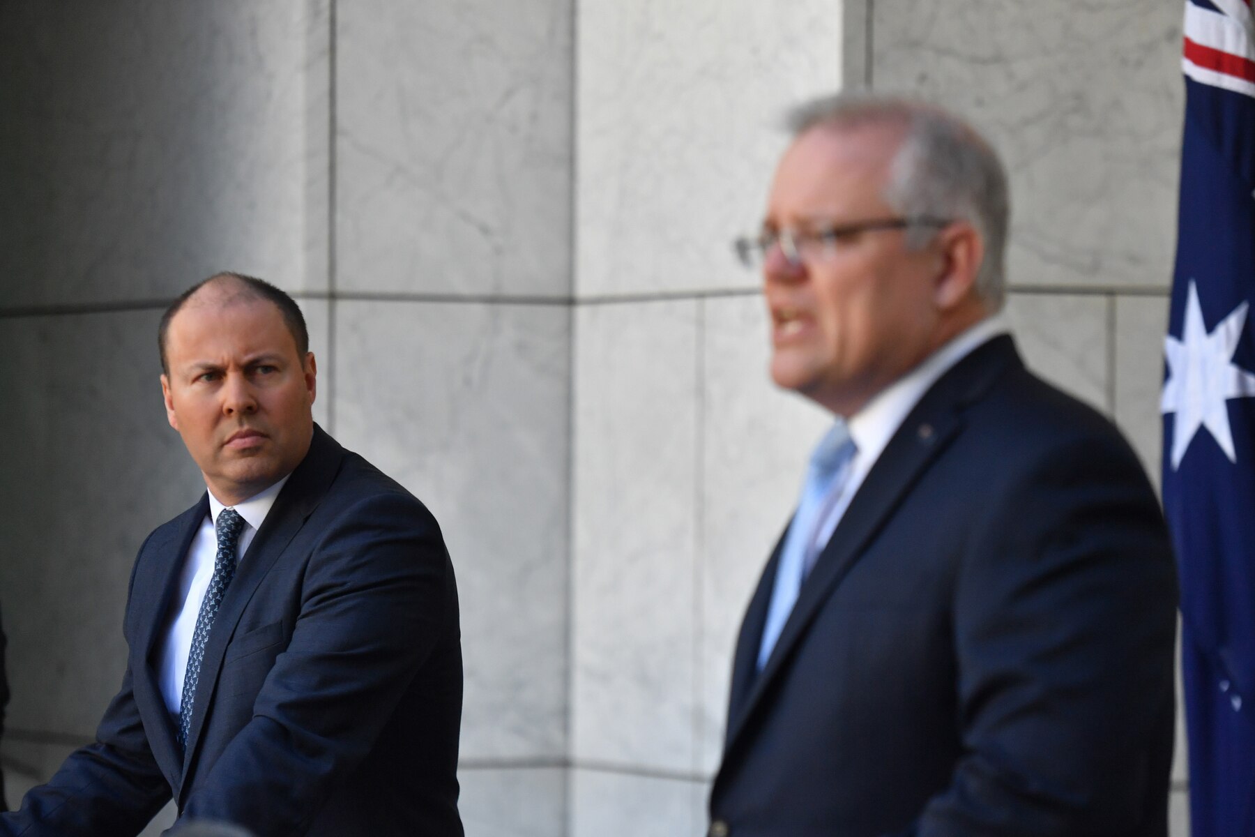 Treasurer Josh Frydenberg and Prime Minister Scott Morrison at a press conference to announce the government's coronavirus stimulus package at Parliament House in Canberra, Sunday, March 22, 2020.
