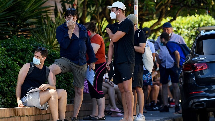 Members of the public queue for a COVID-19 PCR test at a doctors surgery in Sydney.