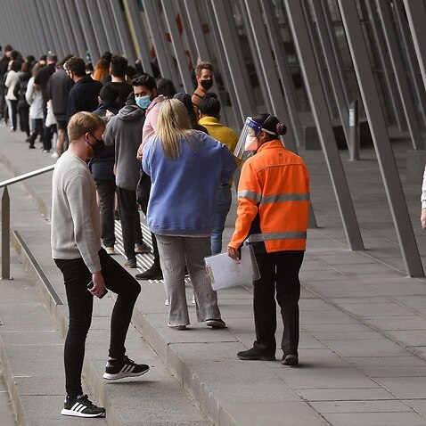 People form long queues outside a vaccination centre in Melbourne
