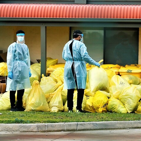 Medical staff and piles of clinical waste is seen at St. Basil's Homes for the Aged inMelbourne, July 27, 2020. 