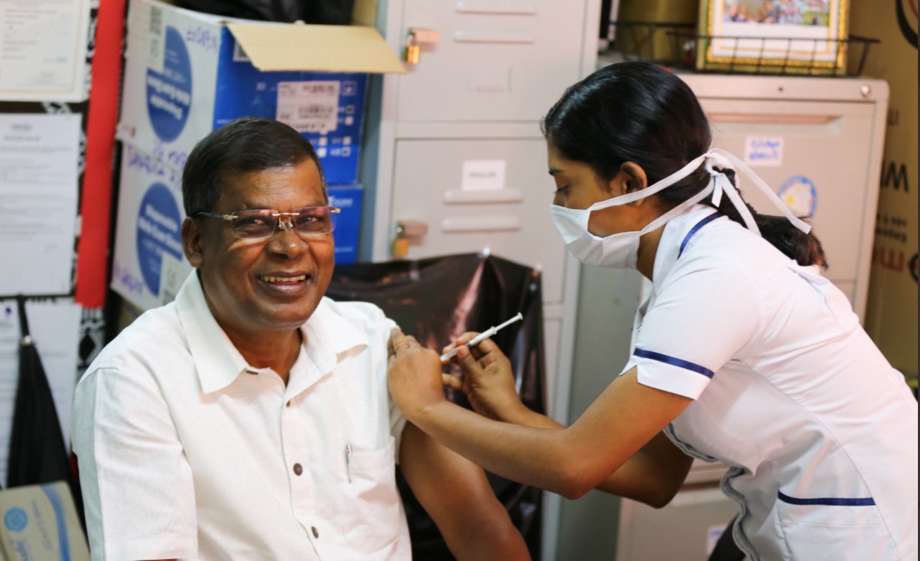 Fiji Opposition Leader Biman Prasad receives a COVID-19 vaccine.