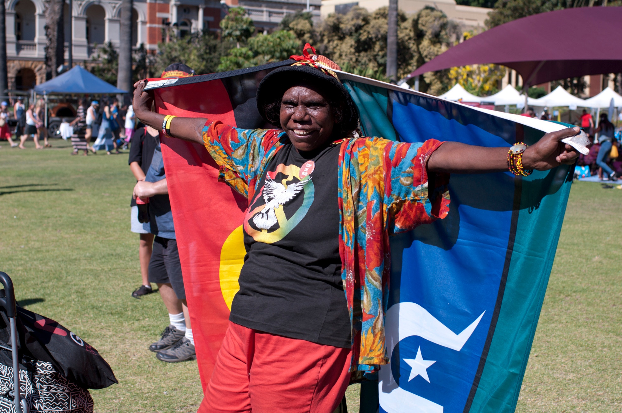 AUSTRALIA, Perth: A woman holds the Aboriginal and Torres Strait Island flags during the Make Smoking History Survival Day Concert at the Supreme Court Gardens on January 26, 2015. 