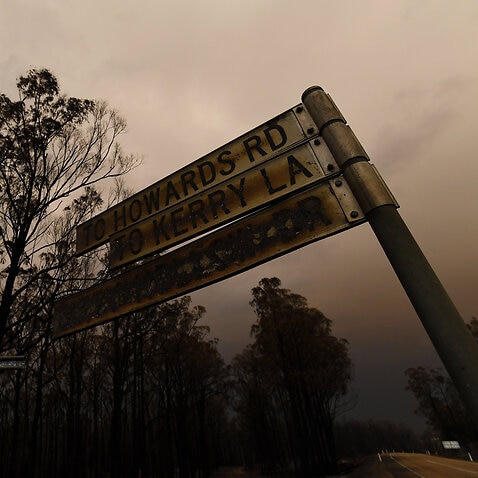 A scorched street sign is seen following a bushfire in Bruthen South, Victoria.