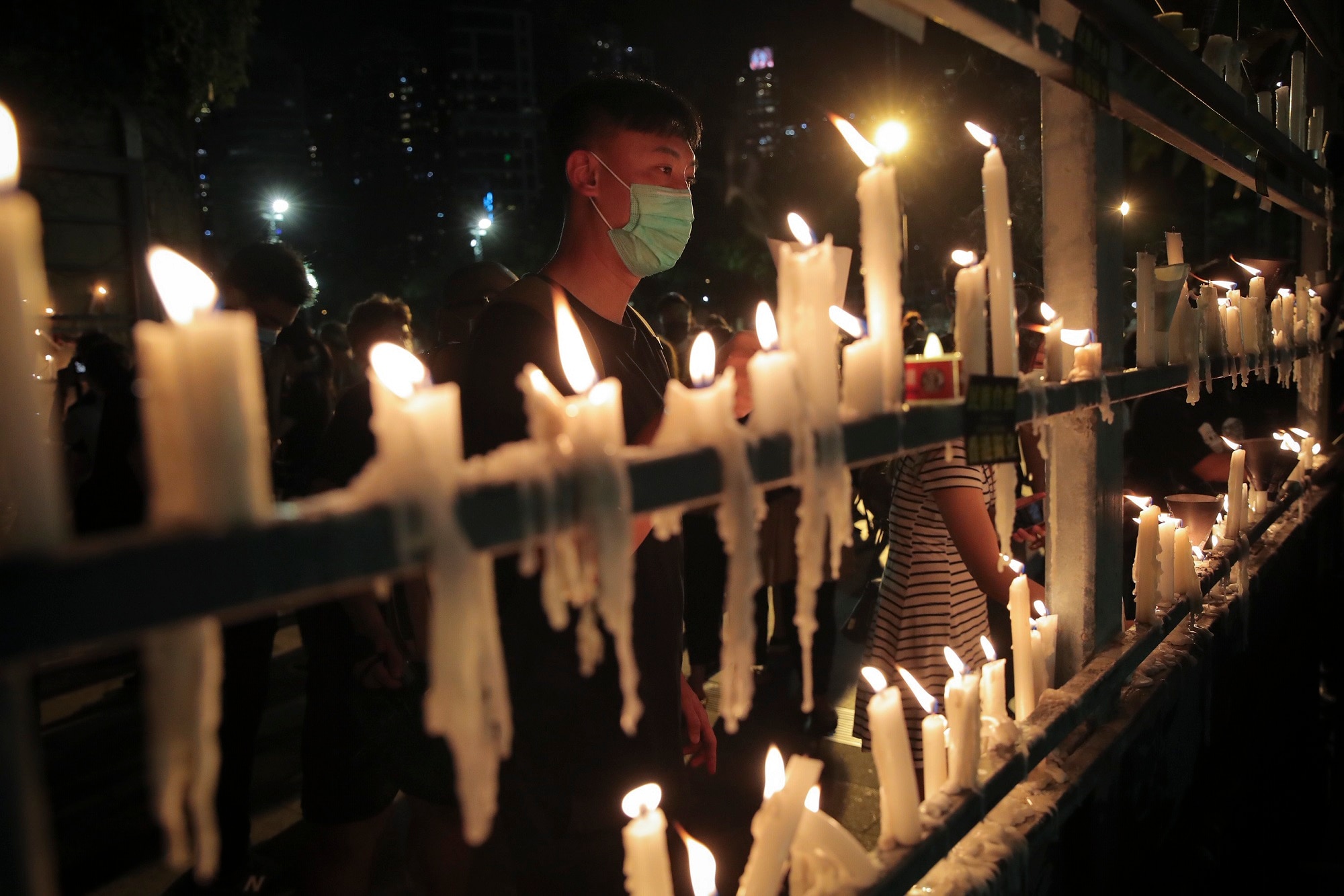 Participants light candles during a vigil for the victims of the 1989 Tiananmen Square Massacre at Victoria Park in Causeway Bay, Hong Kong on 4 June 2020.