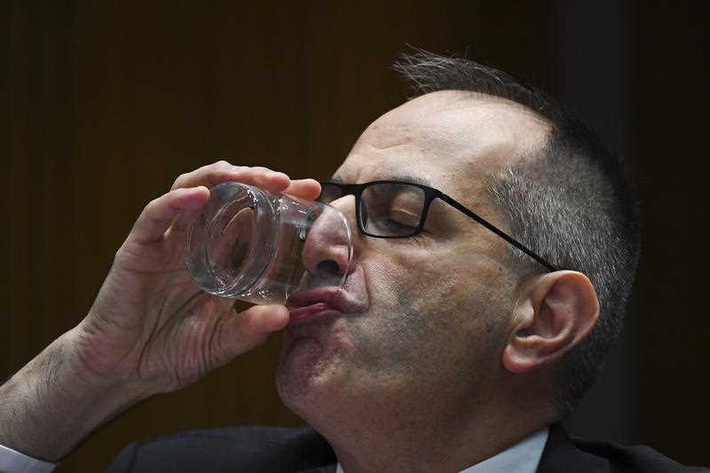 Home Affairs Secretary Mike Pezzullo drinks a glass of water during a Senate Estimates hearing on Monday March 2