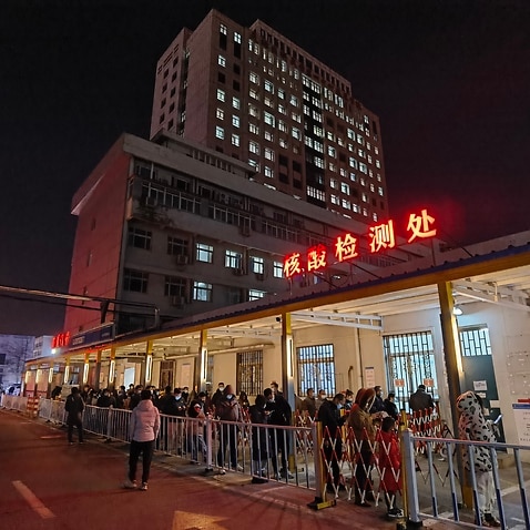 People stand in a queue to receive a COVID-19 nucleic acid test at the testing site in Tianjin 4th Center Hospital on 8 January, 2022 in Tianjin, China. 