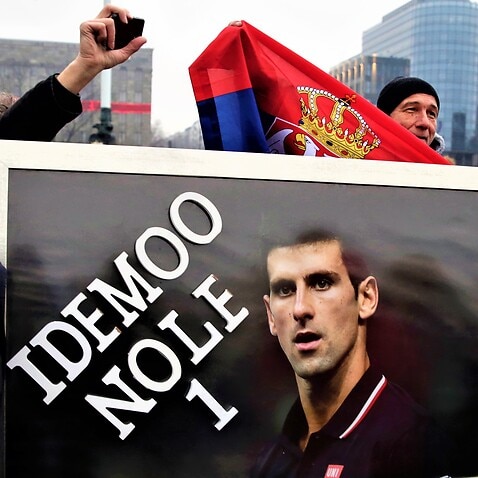 Supporter of Serbian tennis player Novak Djokovic hold a banner during a protest of support in Belgrade, Serbia, 08 January 2022. 