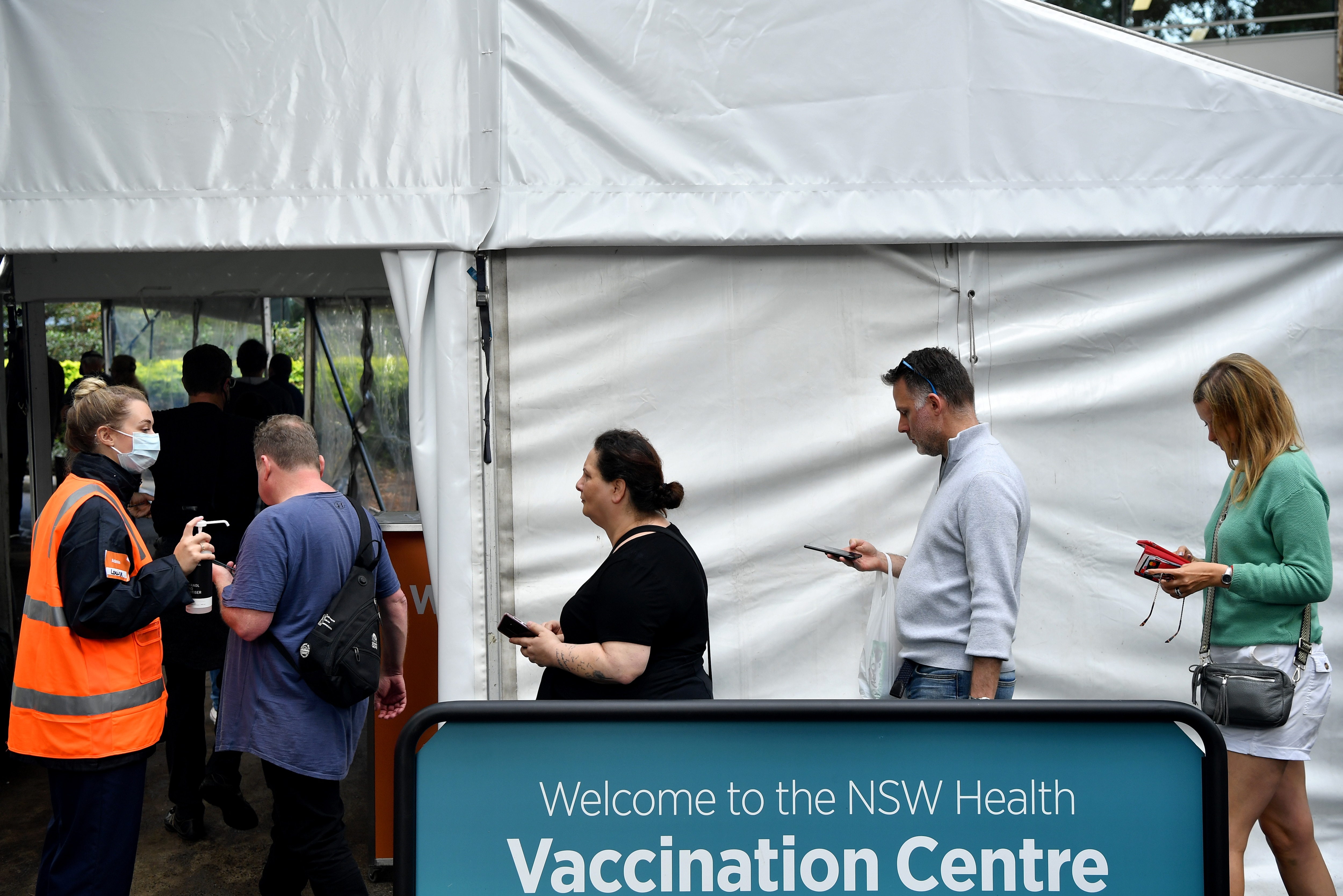 Members of the public wait for a vaccine at a mass COVID-19 vaccination hub in Sydney, Monday, May 24, 2021. (AAP Image/Joel Carrett) NO ARCHIVING