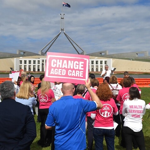 Aged care workers are seen protesting outside Parliament House in Canberra, Wednesday, March 30, 2022.