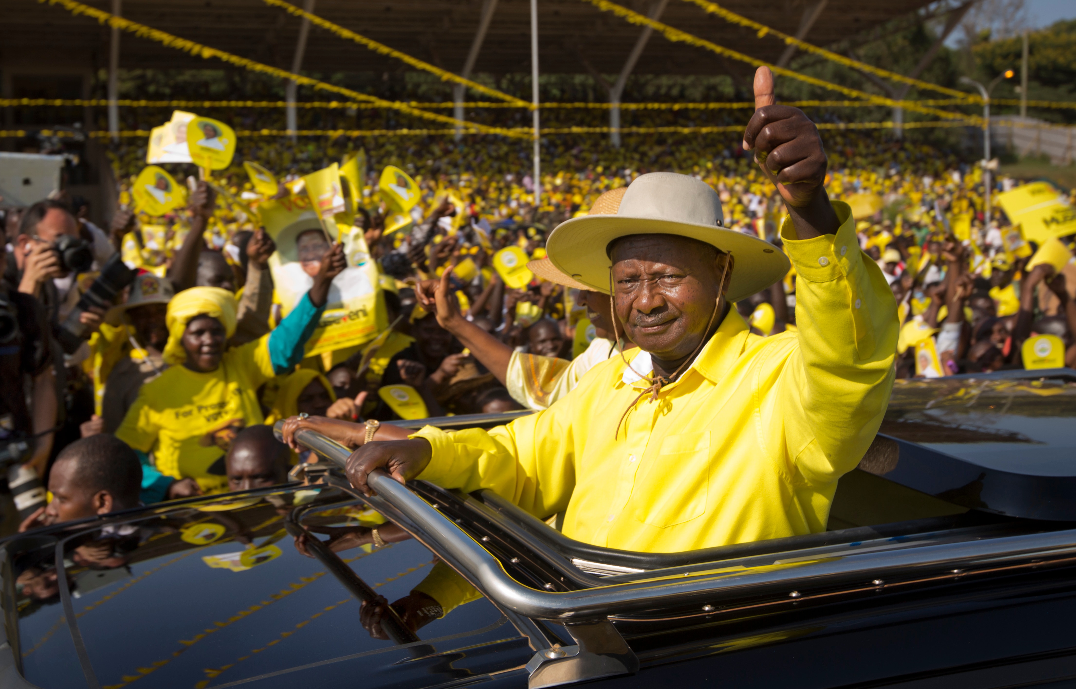 Yoweri Museveni waves to supporters as he arrives for an election rally at Kololo Airstrip in Kampala, Uganda in 2016.