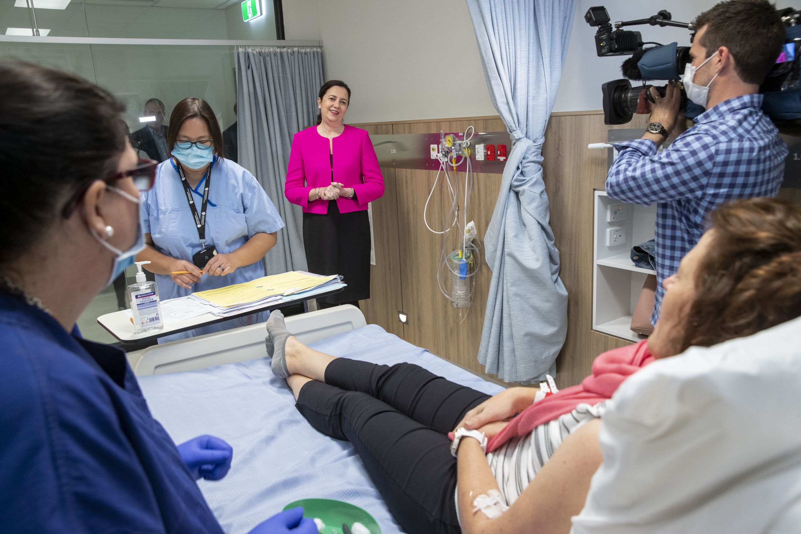 Premier Annastacia Palaszczuk speaks with the first volunteer to be given the COVID-19 vaccine.