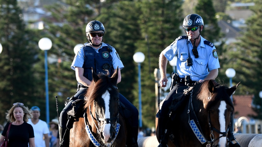 Mounted police patrol a closed Coogee Beach in Sydney.