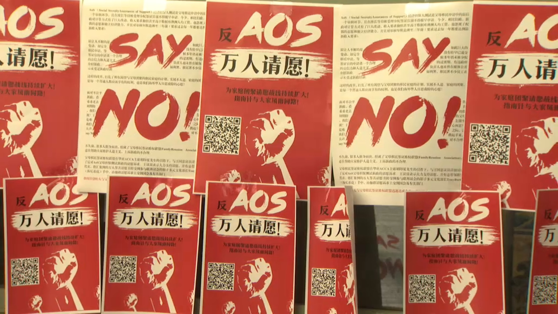 Chinese posters urging the government to overturn the changes at a weekend protest in Sydney. 