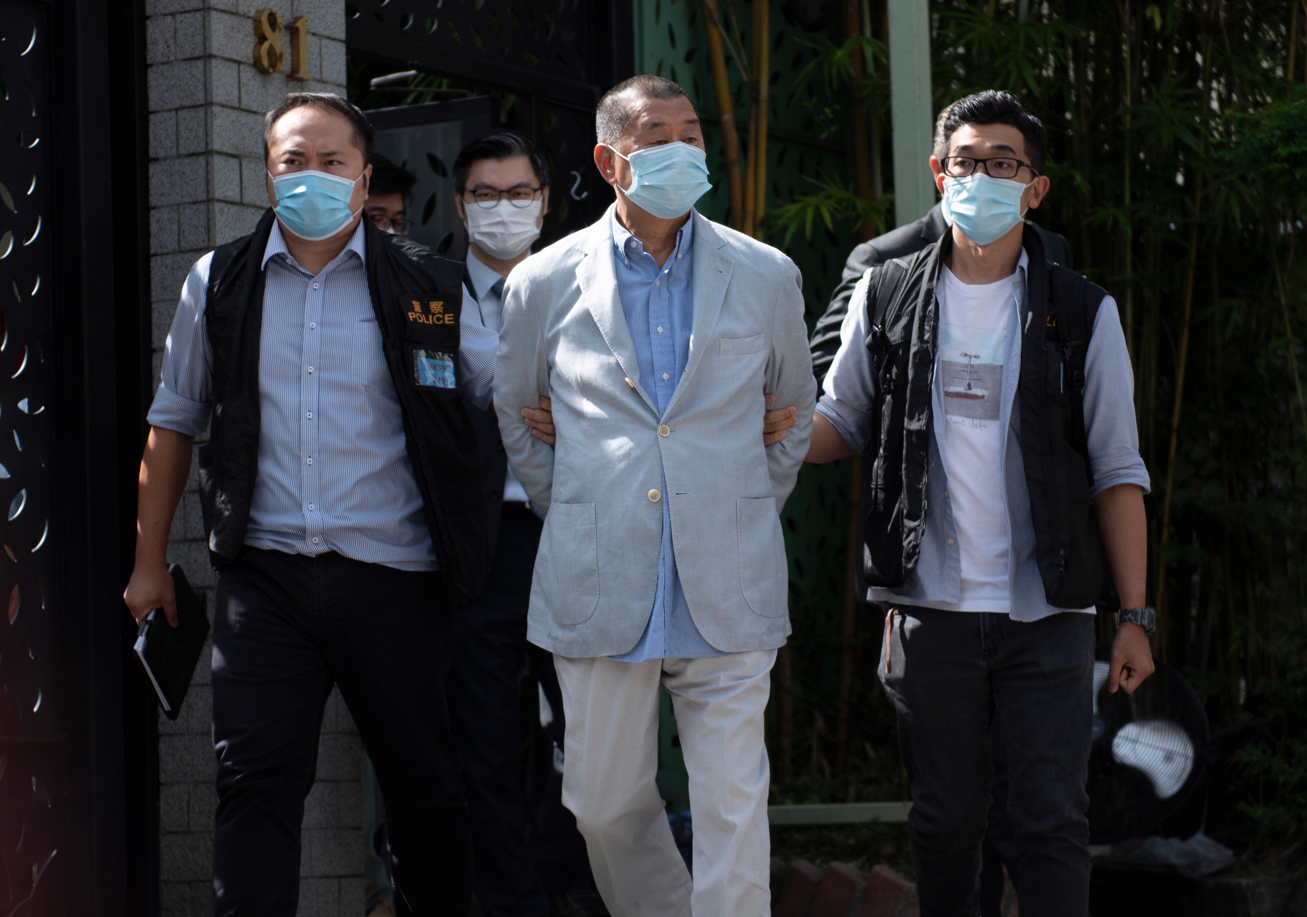 Jimmy Lai is escorted by police after he was arrested at his home in Hong Kong, China.