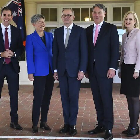 Prime Minister Anthony Albanese(centre) poses for photographs with interim ministers after a swearing-in ceremony at Government House in Canberra on Monday