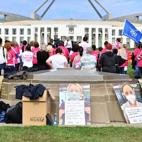 Aged care workers are seen protesting outside Parliament in March