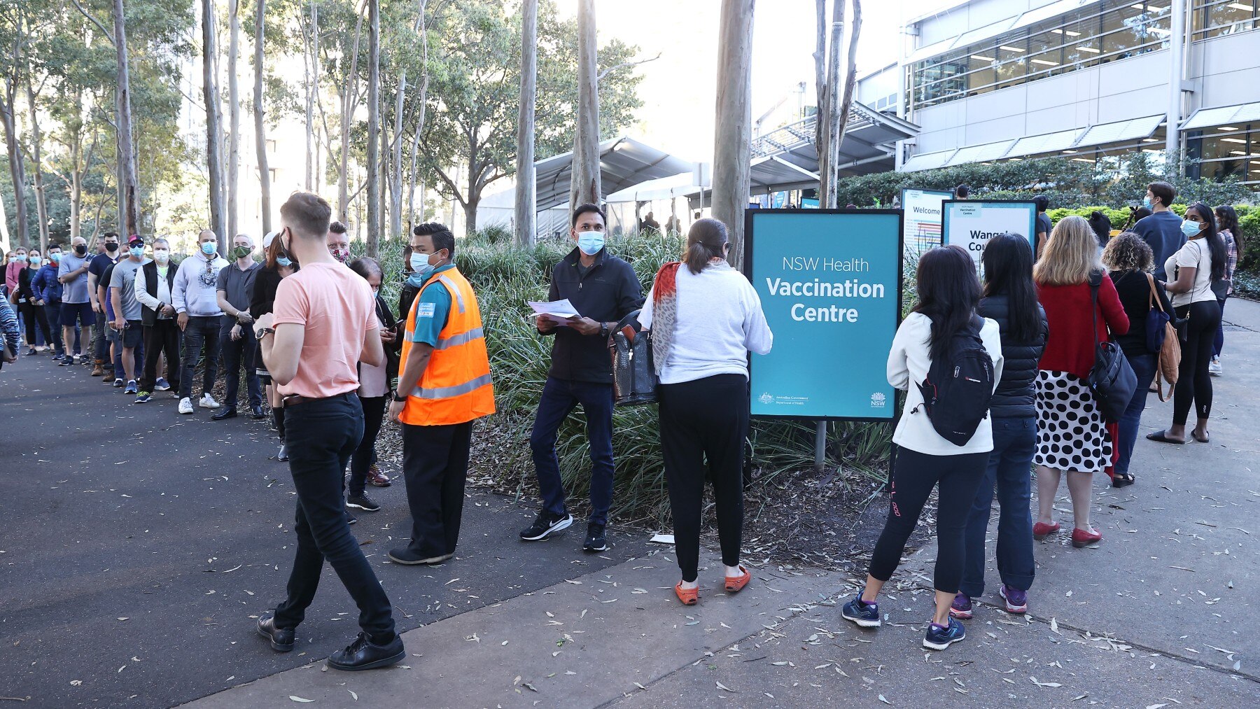 People are seen queuing to enter a mass COVID-19 vaccination hub on May 10, 2021 in Sydney, Australia. 