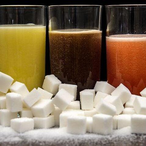 Sugary drinks surrounded by sugar cubes.