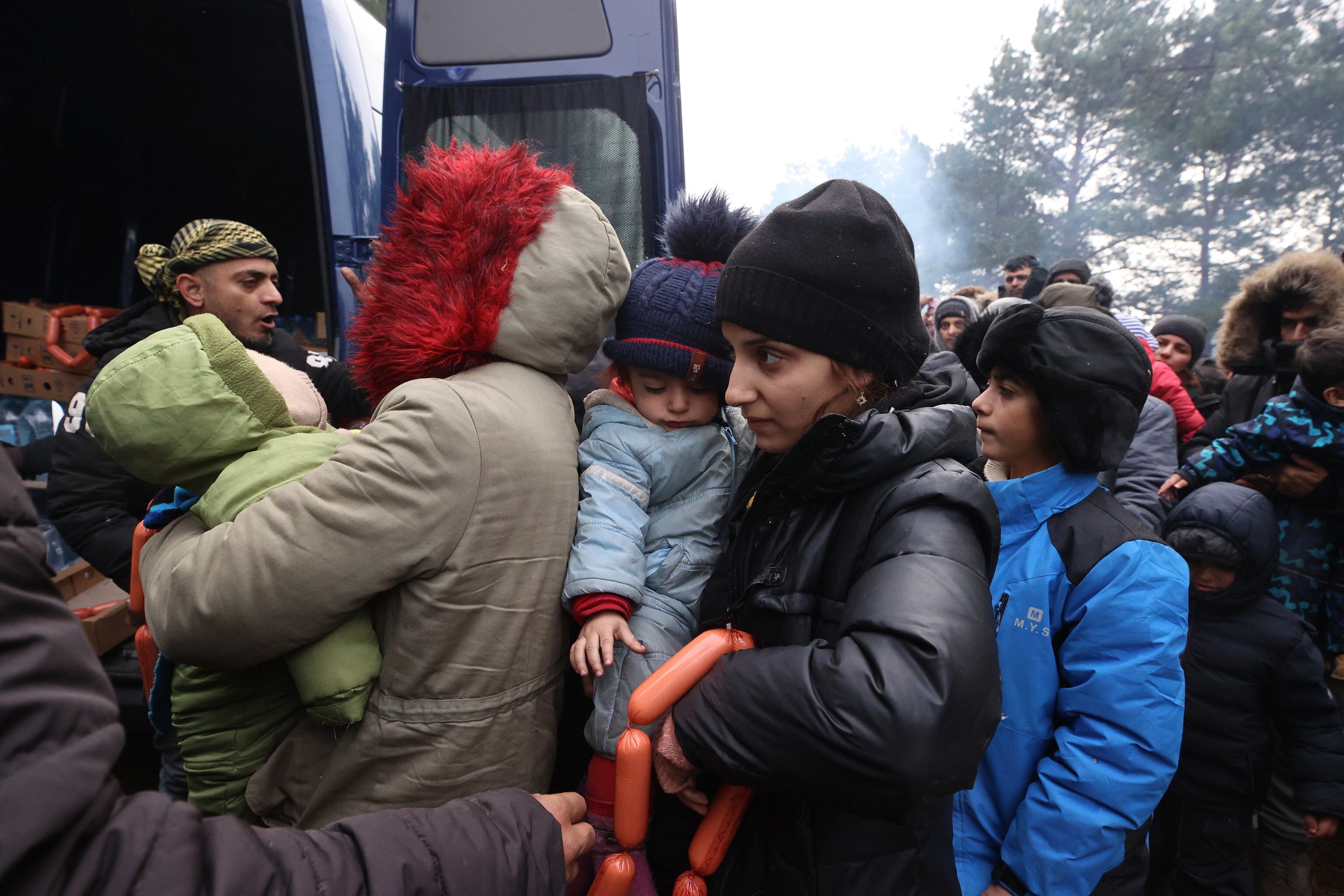 Migrants receiving humanitarian aid in the camp