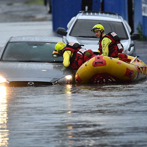 A search team is seen with flooded cars on Longlands Street at Woolloongabba in Brisbane, Tuesday, October 27, 2020.
