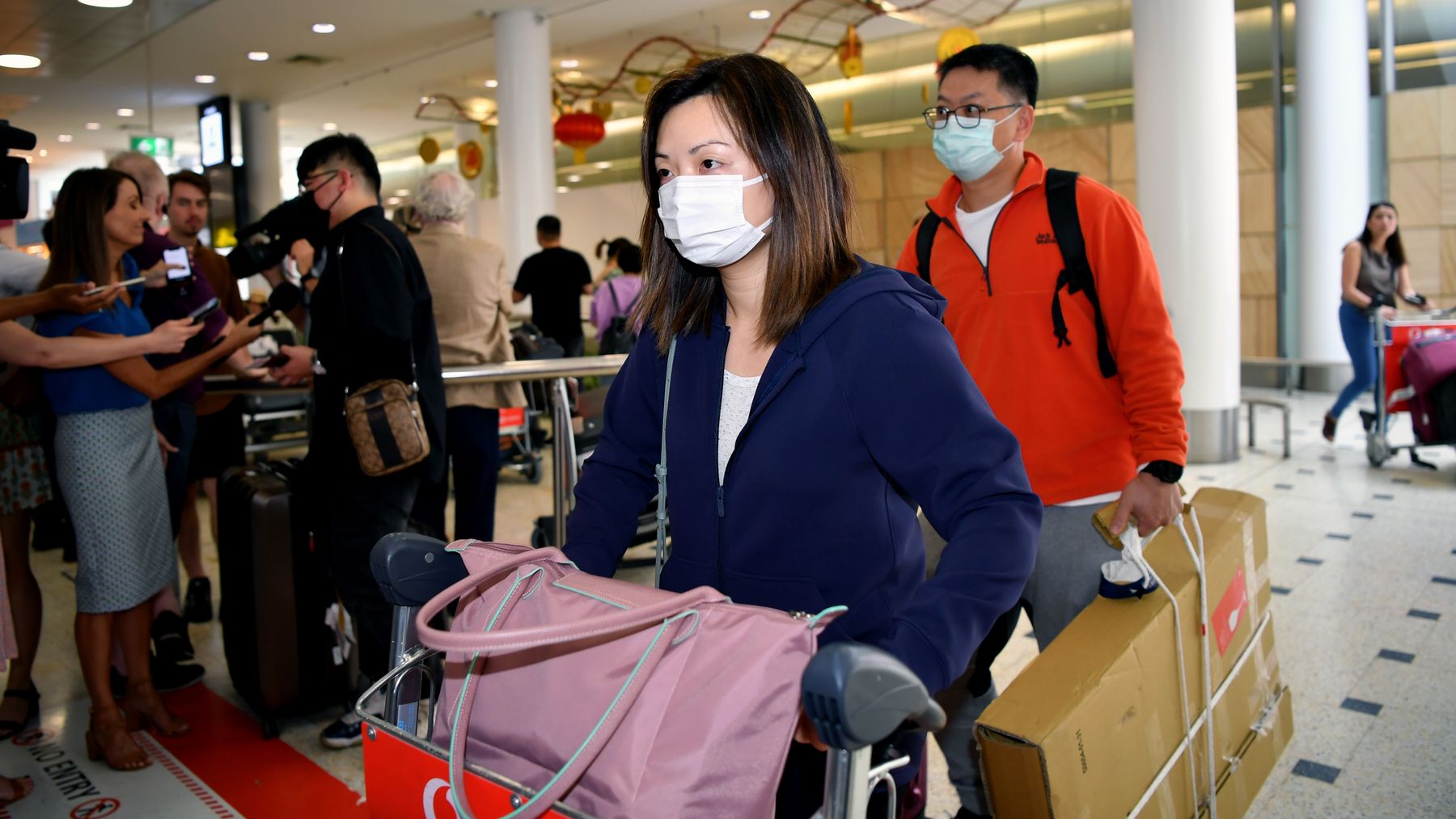 Passengers wearing a protective masks on arrival at Sydney International Airport in Sydney.