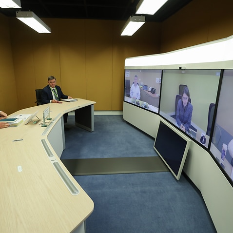 Prime Minister Scott Morrison and Chief Medical Officer Professor Brendan Murphy speak with (on screen) Jim McDowell, Chief Executive of the South Australia Department of Premier and Cabinet, Premier of NSW Gladys Berejiklian and Premier of Western Austra