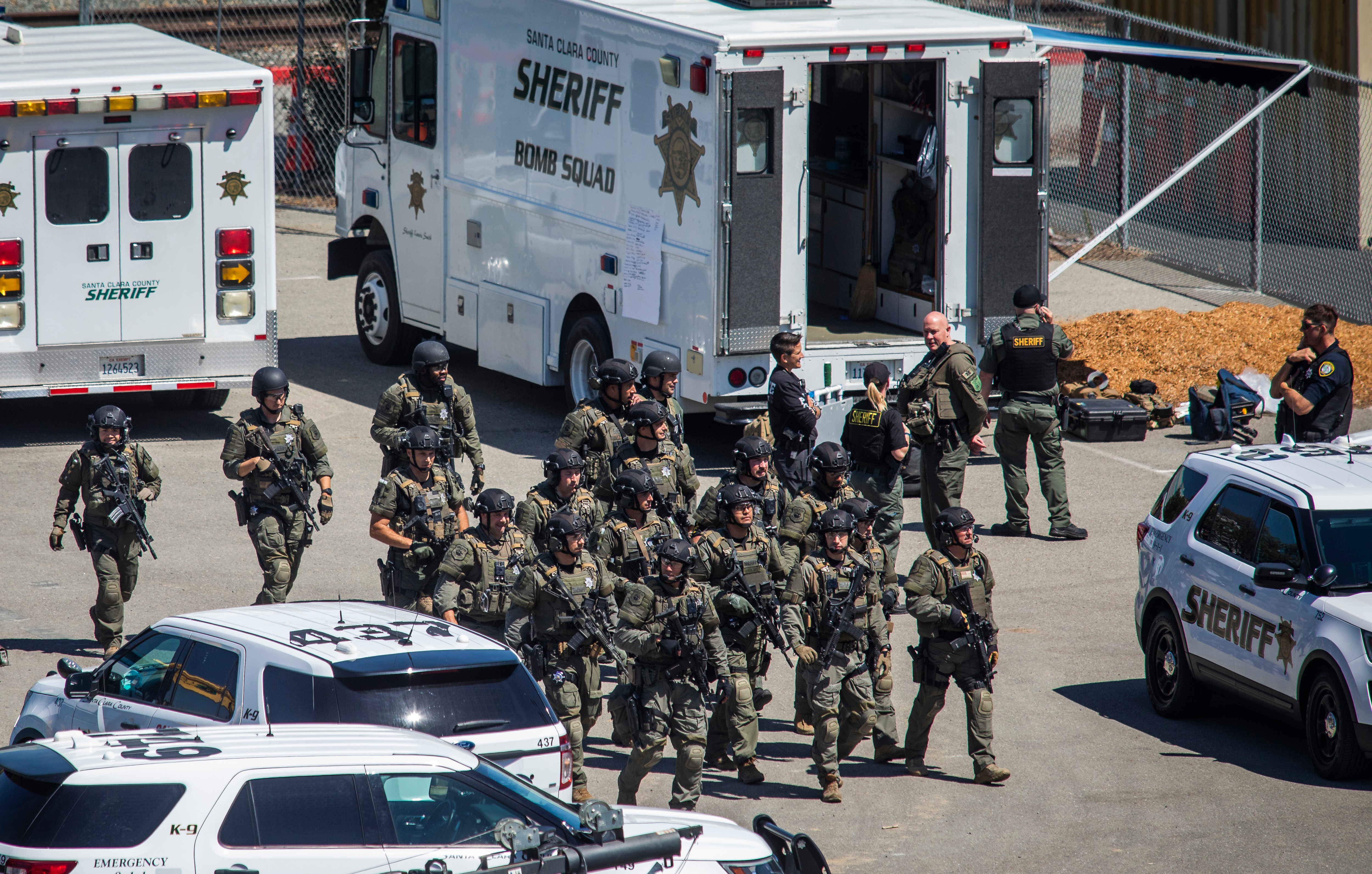 Tactical law enforcement officers move through the Valley Transportation Authority (VTA) light-rail yard where a mass shooting occurred on 26 May 2021.