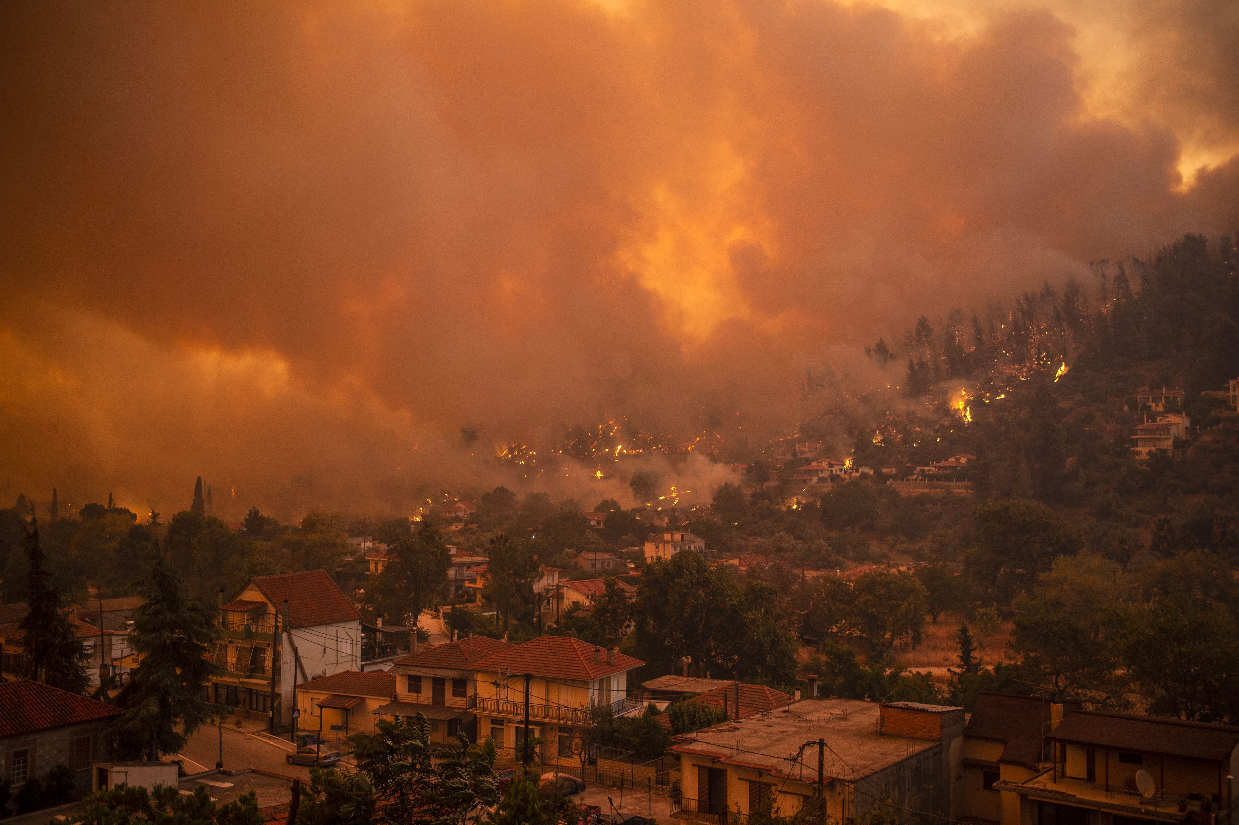 A wildfire moves towards the village of Gouves on Evia island on Greece on 8 August, 2021. 