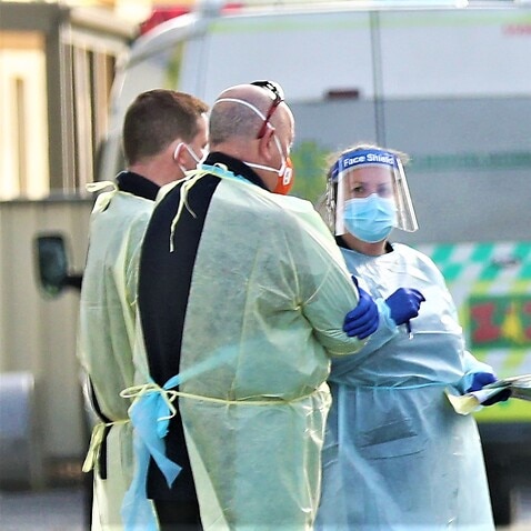 Medical staff are seen preparing to transport people from the St Basils Home for the Aged Care which has had an outbreak of COVID-19, Melbourne, July 25, 2020.