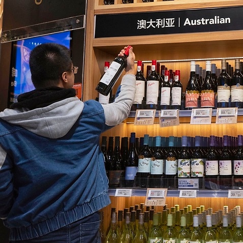 A man examines Australian wine in Shanghai, China.