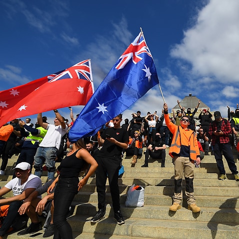 Protesters are seen at a demonstration against mandatory Covid-19 vaccinations and a two week shutdown of the construction industry at the Shrine of Remembrance in Melbourne, Wednesday, September 22, 2021.  (AAP Image/James Ross) NO ARCHIVING