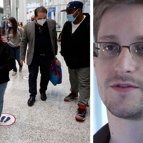 Edward Snowden, who worked as a contract employee at the National Security Agency, Nadeeka Dilrukshi Nonis holds the hand of her son Dinath, and Supun Thilina Kellapatha (R) speaks with lawyer Marc-Andre Seguin (2R), as they arrive in Canada as refugees