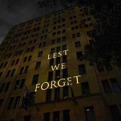 The words Lest We Forget are projected onto a building during the Anzac Day Dawn service at Martin Place in Sydney, Wednesday, April 25, 2018.