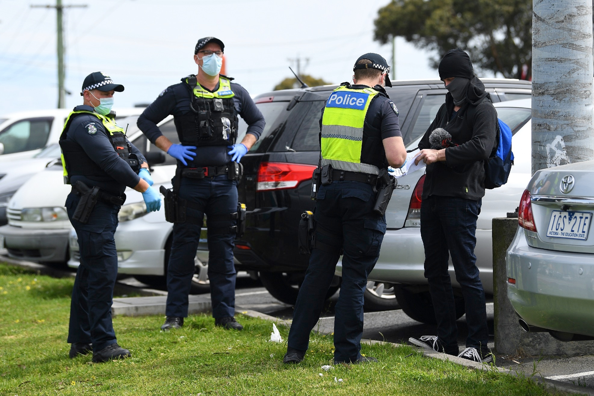Victorian police speak to protesters at a rally near Campbellfield Plaza in Melbourne.