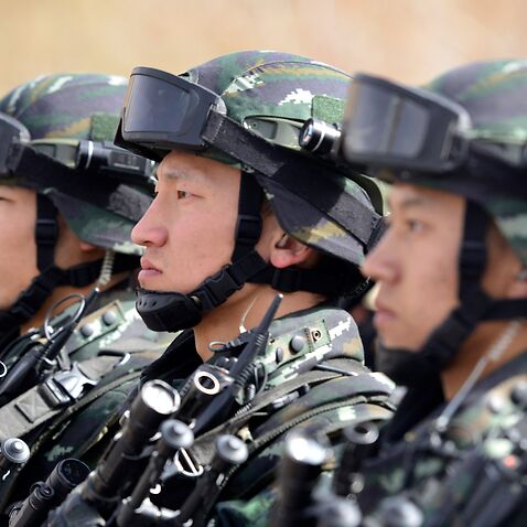 This photo taken on February 27, 2017 shows Chinese military police attending an anti-terrorist oath-taking rally in Hetian, northwest China's Xinjiang Uygur Autonomous Region. Islamic State militants from China's Uighur ethnic minority have vowed to retu