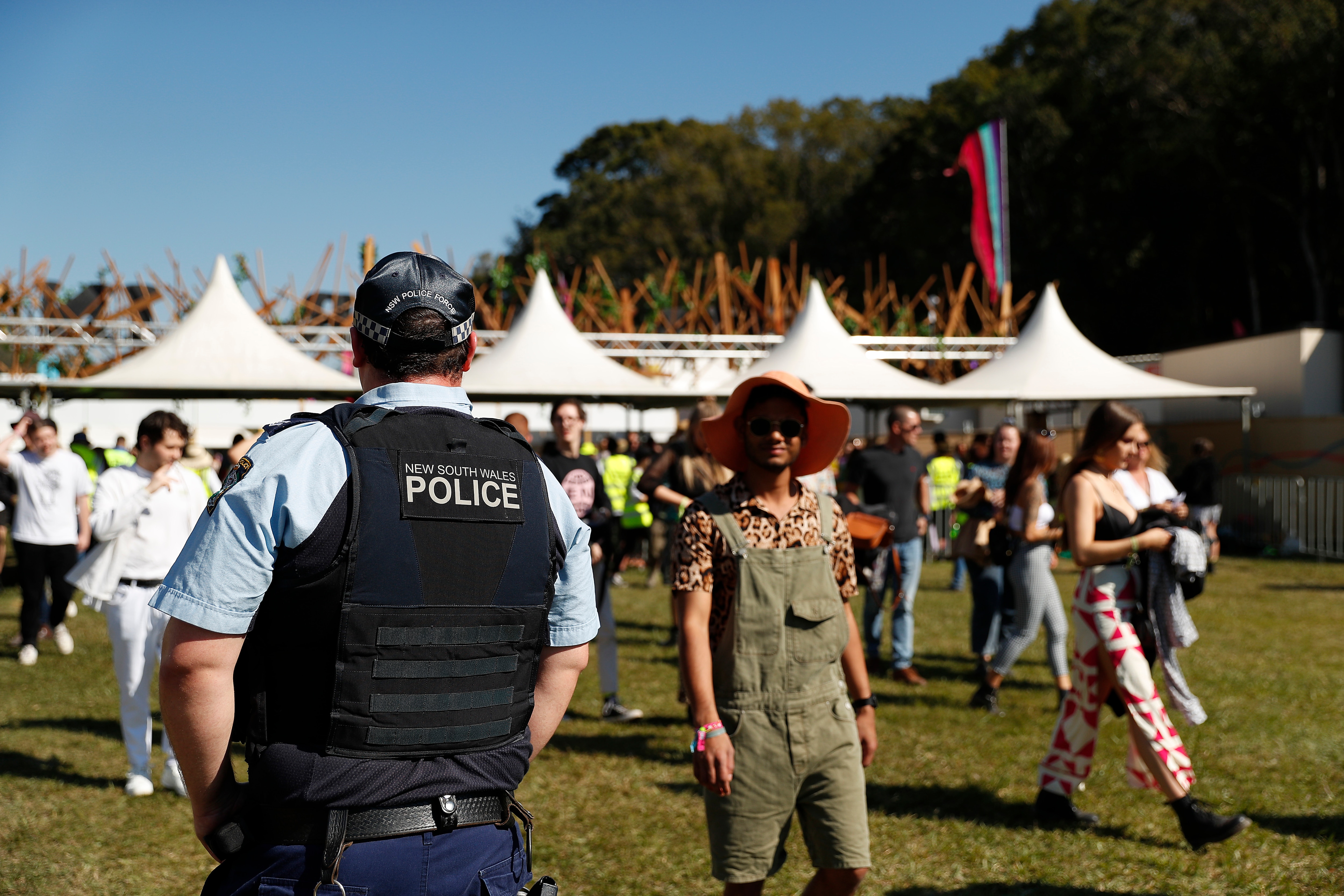 Police officers and drug detection dogs walk amongst festival goers by an entrance to Splendour In The Grass 2019 on July 19, 2019