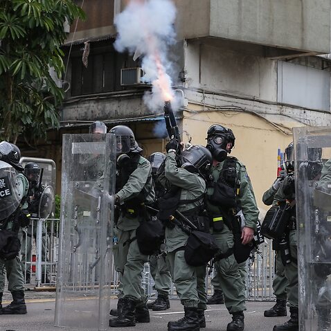 Riot police fire tear gas during a mass rally in Yuen Long, New Territories, Hong Kong, China. 