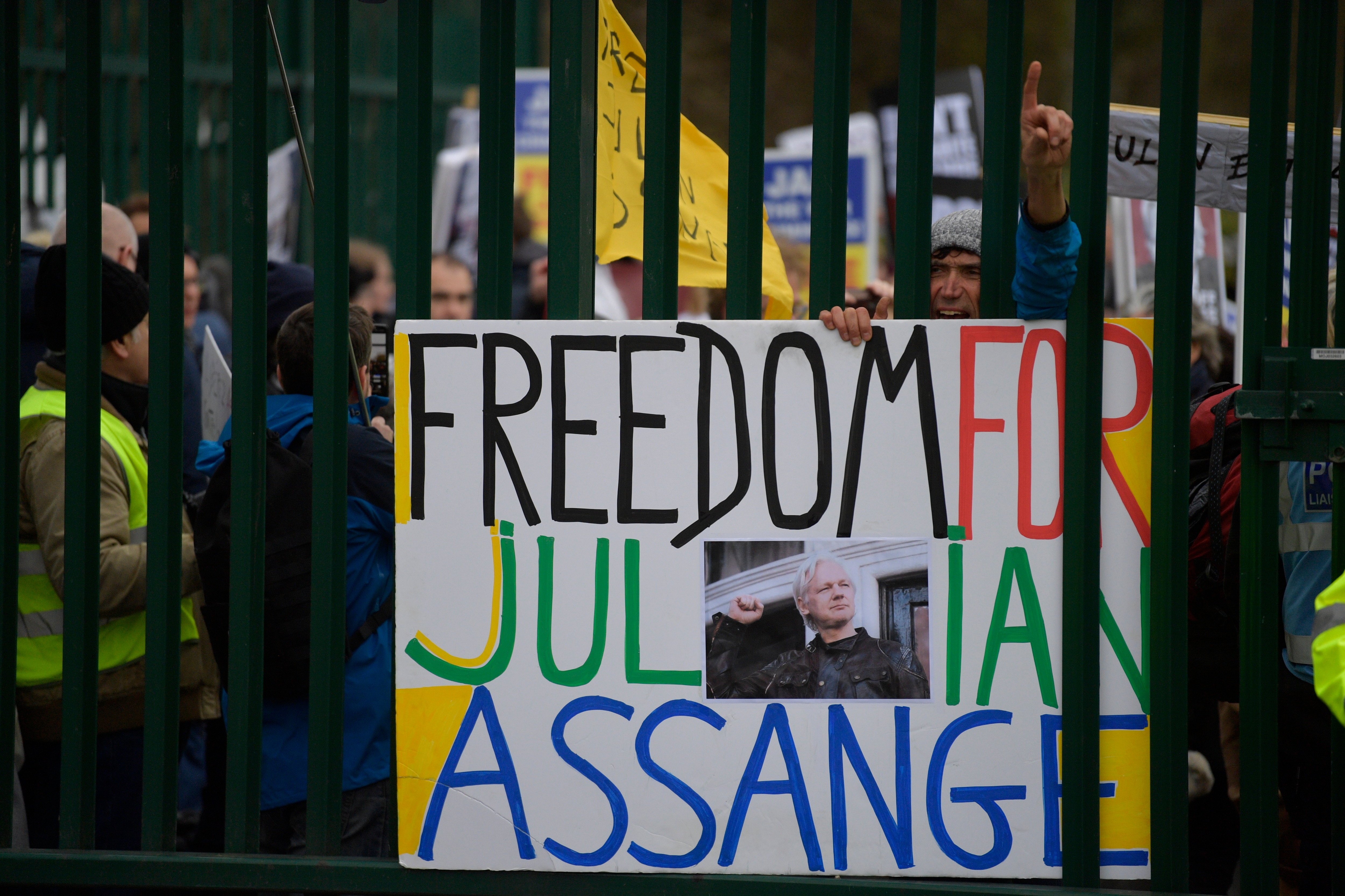 Supporters of Wikileaks founder Julian Assange protest in front of the Woolwich Crown Court in London.