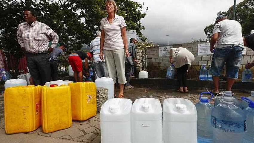 Residents of Cape Town collect drinking water from a mountain spring collection point in Cape Town, South Africa, 19 January 2018