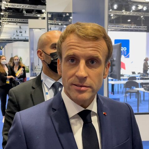 French President Emmanuel Macron speaks to reporters.