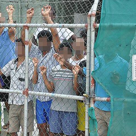 (File Image) Asylum seekers seen behind a fence at the Manus Island detention centre in Papua New Guinea in 2014.