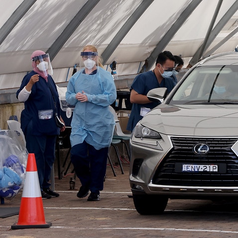 People are tested for COVID-19 at a drive through facility in Sydney, Monday, January 24, 2022. NSW reported its lowest daily COVID-19 tally this year on Monday with 15,091 new cases. (AAP Image/Damian Shaw) NO ARCHIVING