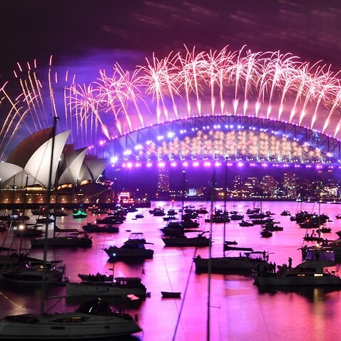 The midnight fireworks light up Sydney Harbour and the Sydney Harbour Bridge during New Year’s Eve celebrations