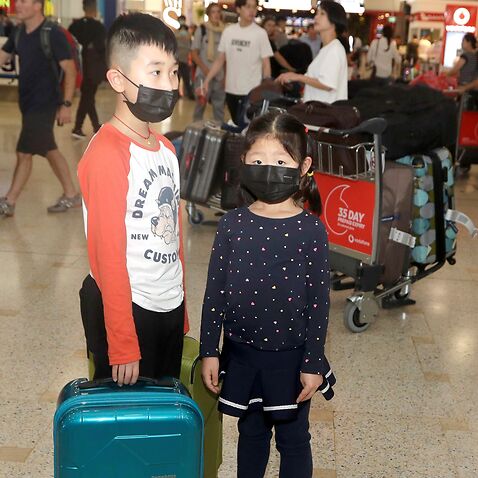 Children, wearing face masks at Sydney airport