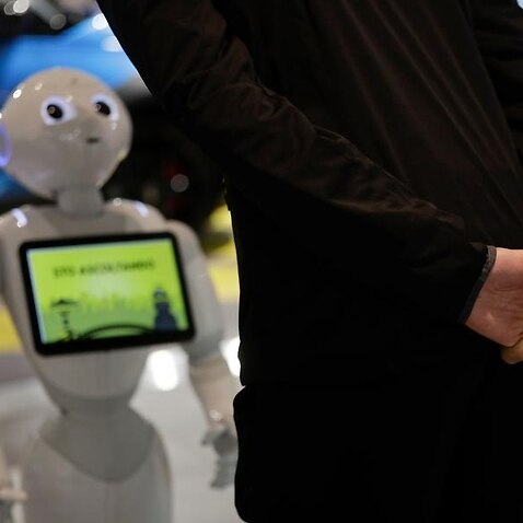 A guests asks a hotel assistance robot for information